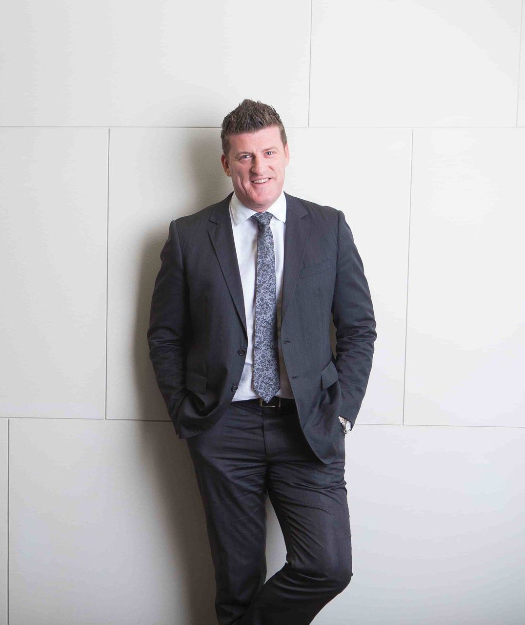 A Man In A Suit And Tie — Harrison Development Group In Surfers Paradise, QLD