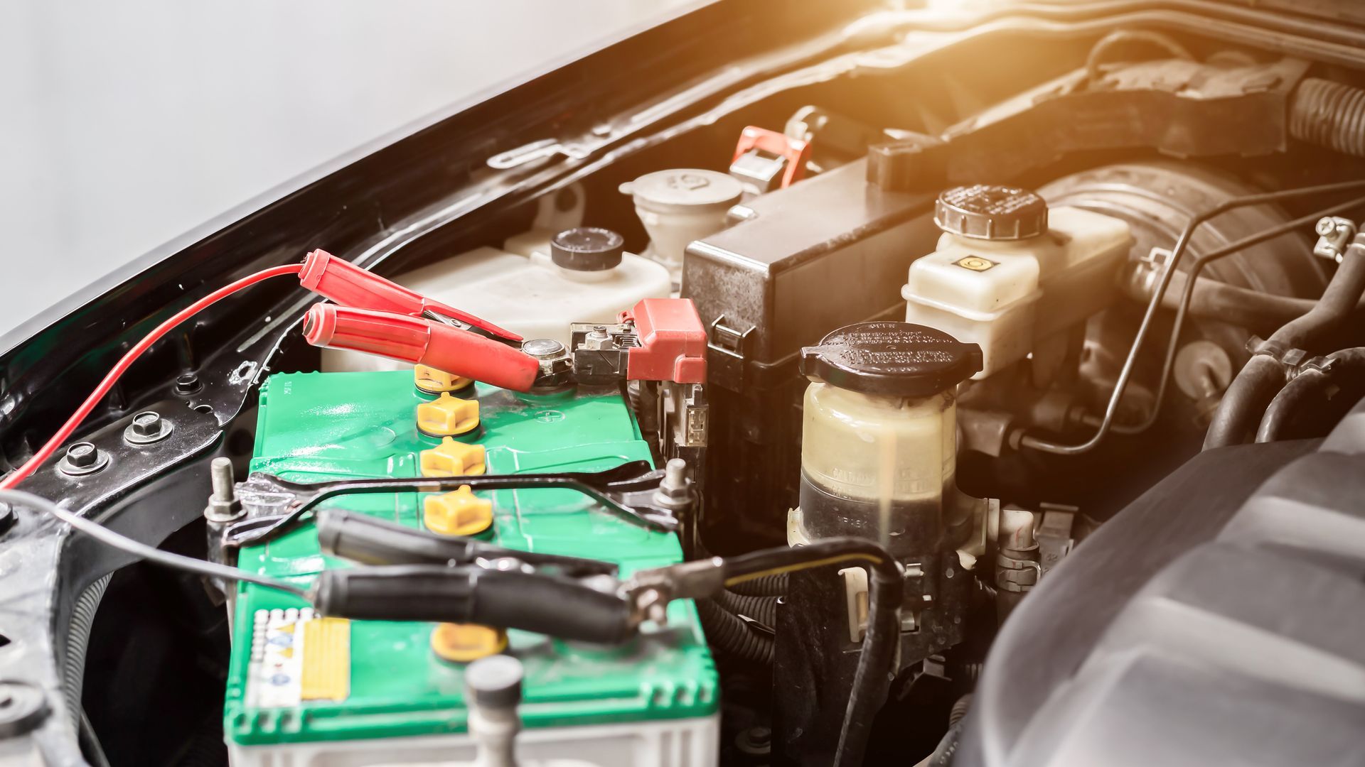 A car battery is being charged with a jump starter.
