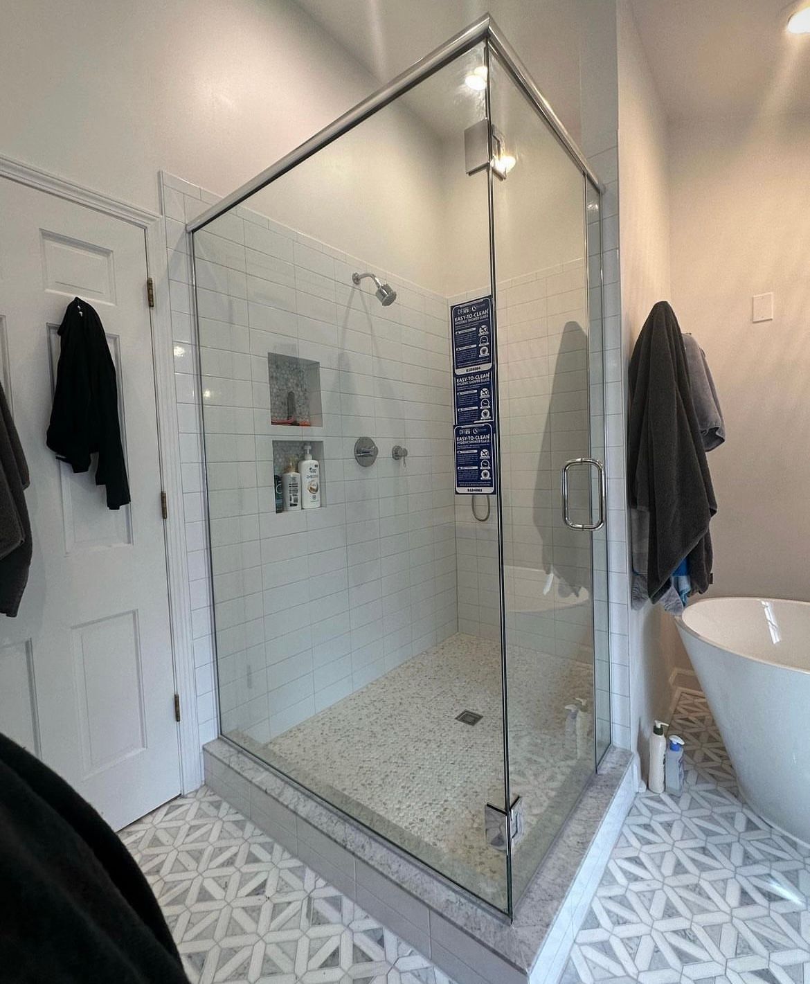 A bathroom with a walk in shower and a bathtub.