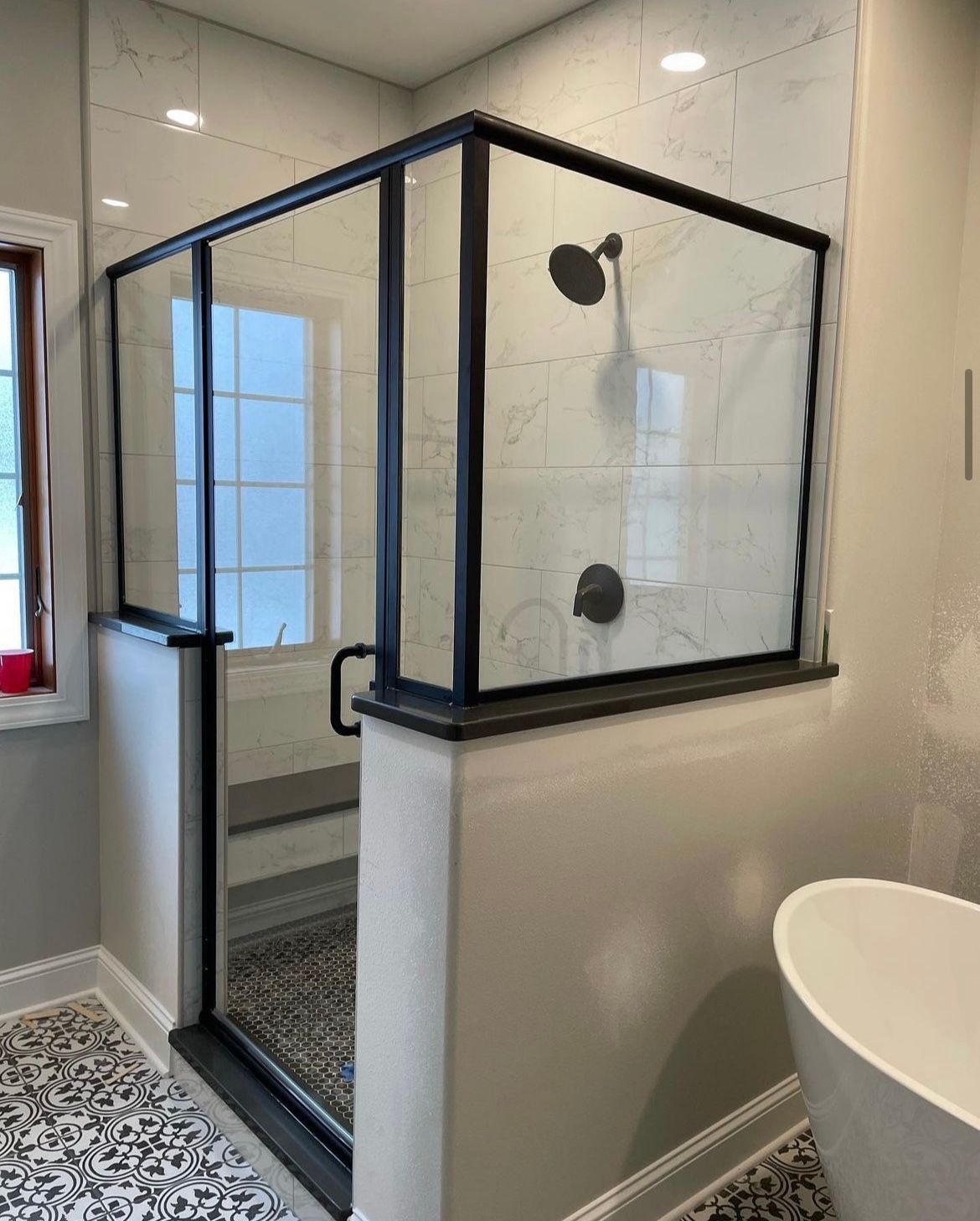 A bathroom with a walk in shower and a bathtub.