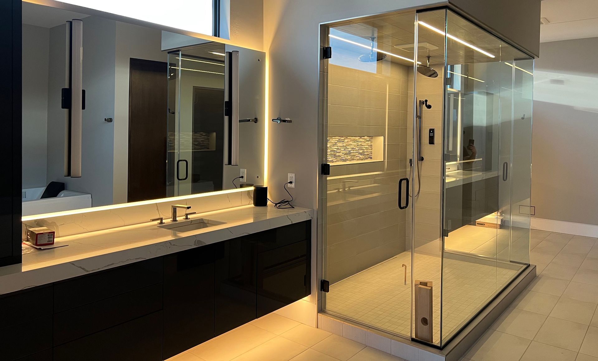A bathroom with a walk in shower and two sinks.