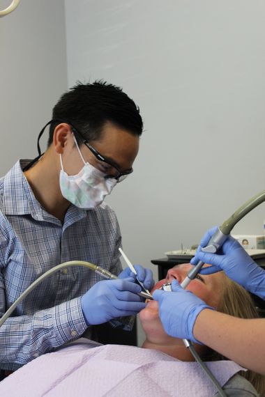 Dr. Alan Nguyen Cleaning a patients teeth