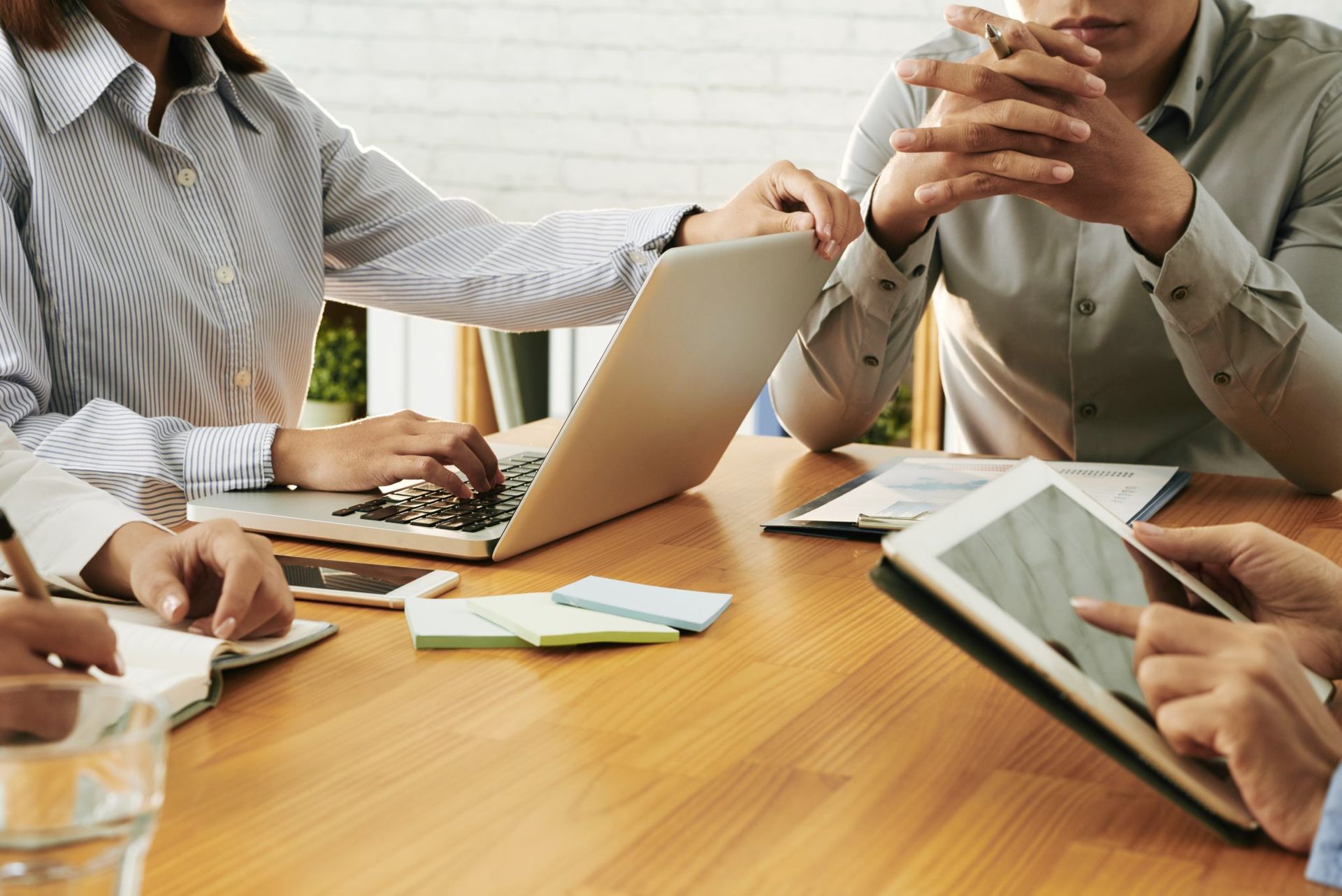 A Group of Businessman in a Meeting with Laptop and Tablet Mobile | Hervey Bay, Qld | Lewis & Mcnamara Solicitors