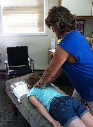 Chiropractor working on Girls Back - Chiropractor in Maynard, MA