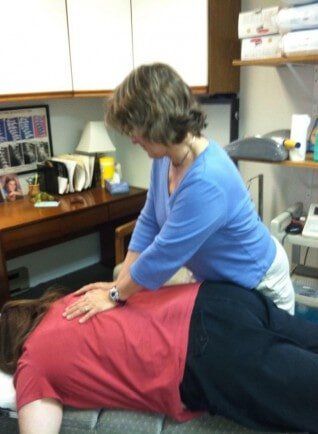 Chiropractor working on womans back - Chiropractor in Maynard, MA