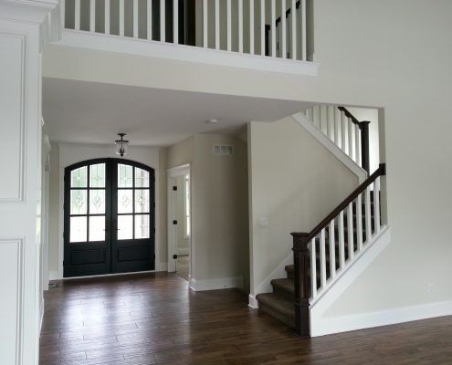 there is a staircase leading up to the second floor of the house .