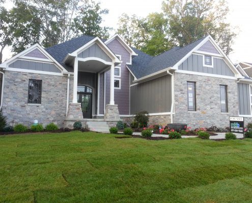 a large house with a lush green lawn in front of it