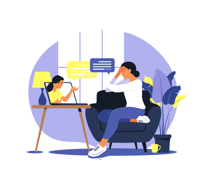 A woman is sitting on a couch looking at a laptop.