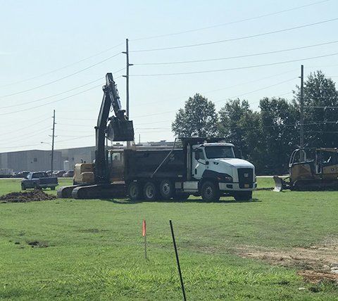 Site Preparation — Construction Trucks and Excavator in Jonesboro, AR
