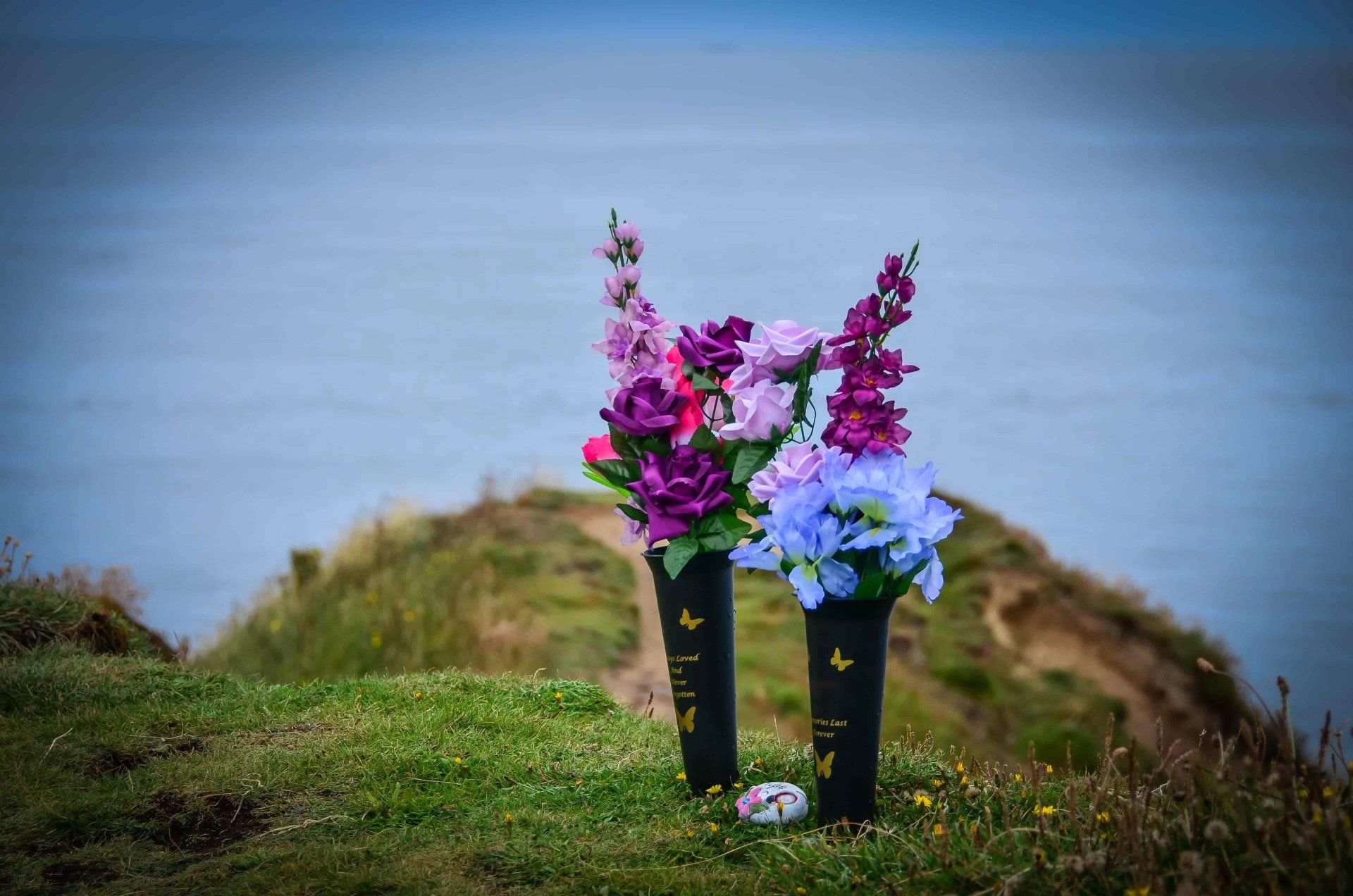 flowers placed on a hill to remember a deceased loved one