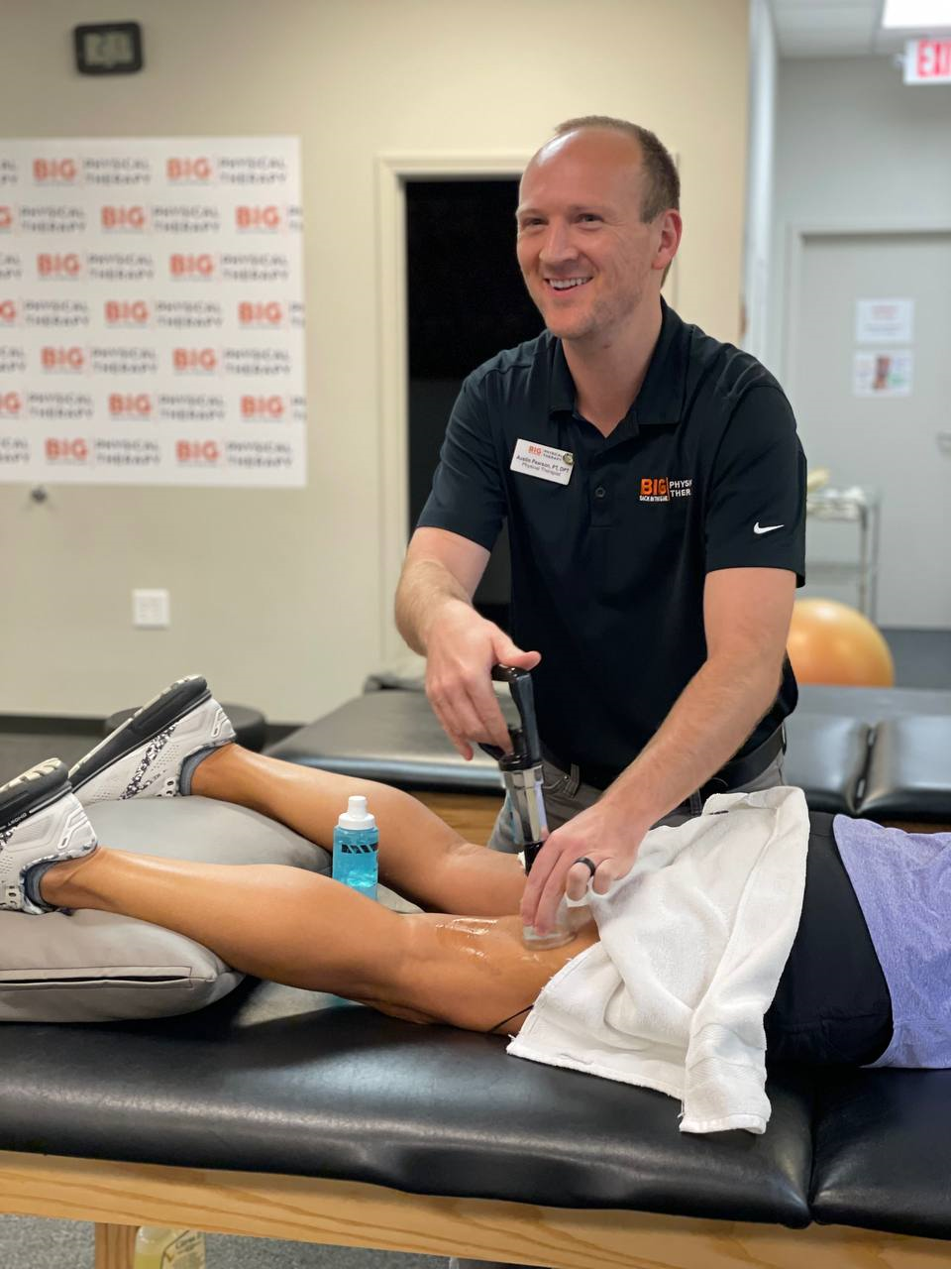 A BIG physical therapist completing musculoskeletal therapy with cupping techniques