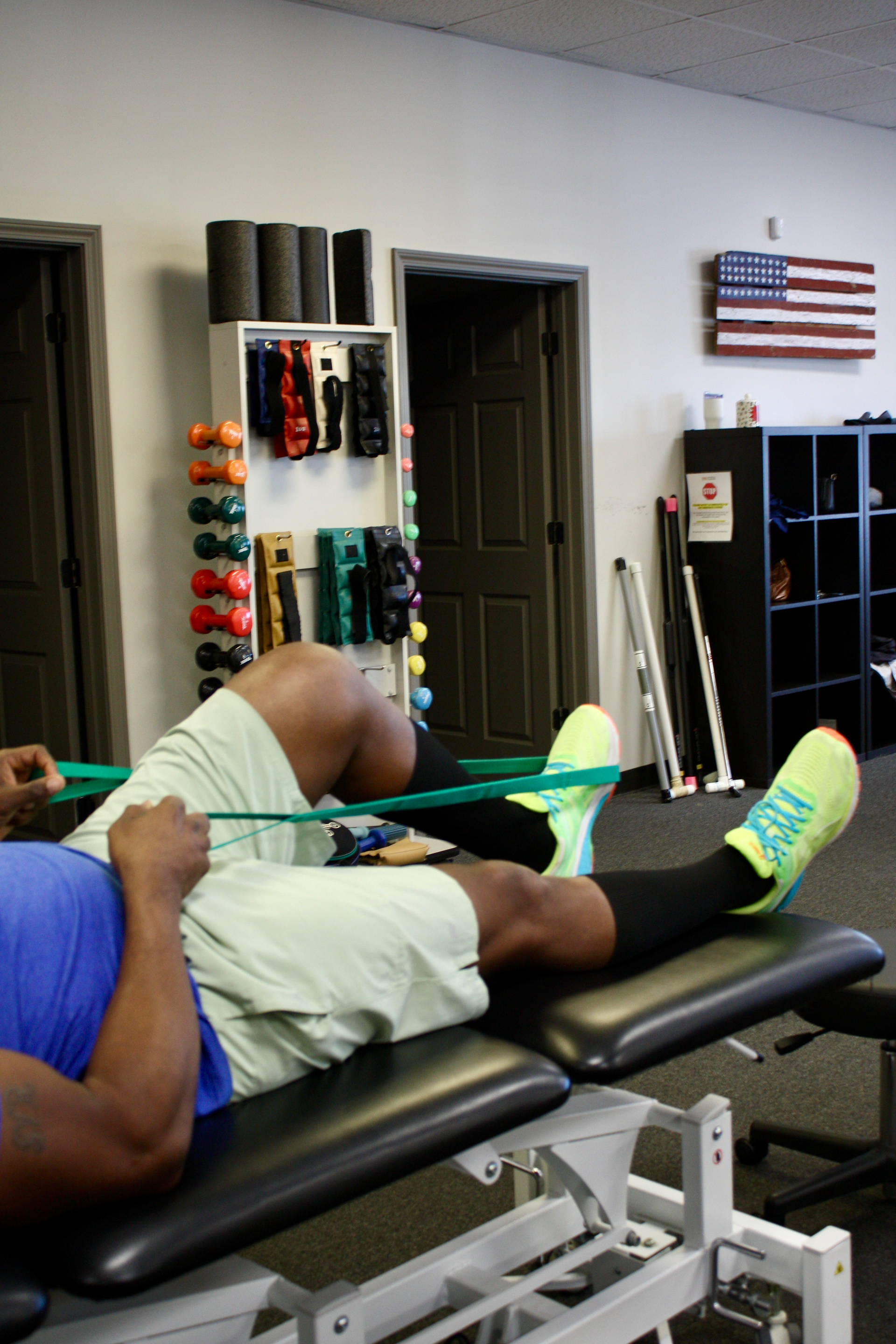 A man is stretching his legs with a resistance band