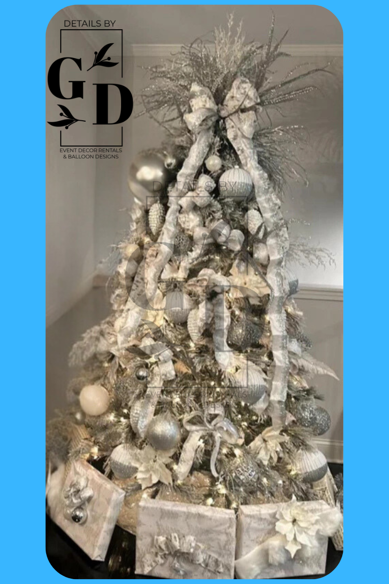 Silver and white Christmas tree decorated with ornaments, ribbon, and gifts.