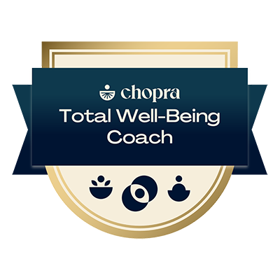 A badge that says chopra total well-being coach