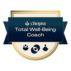 A badge that says chopra total well-being coach