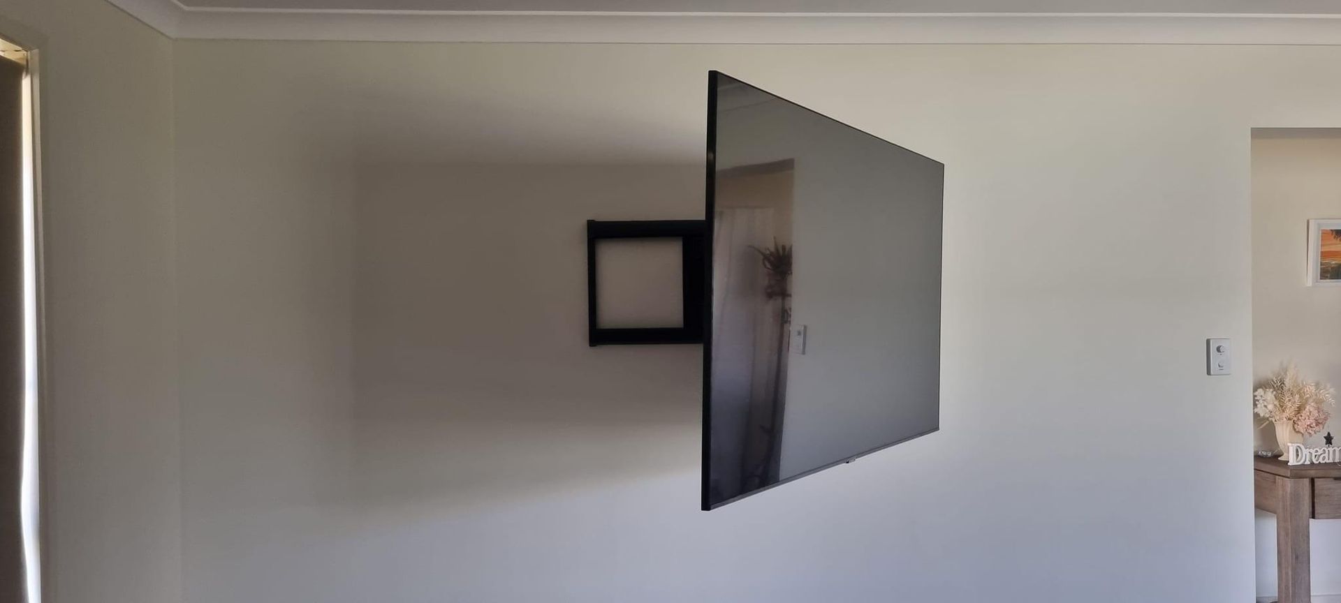 A Flat Screen Tv Is Mounted On A Wall In A Living Room — Highfields Antennas In Cabarlah, QLD