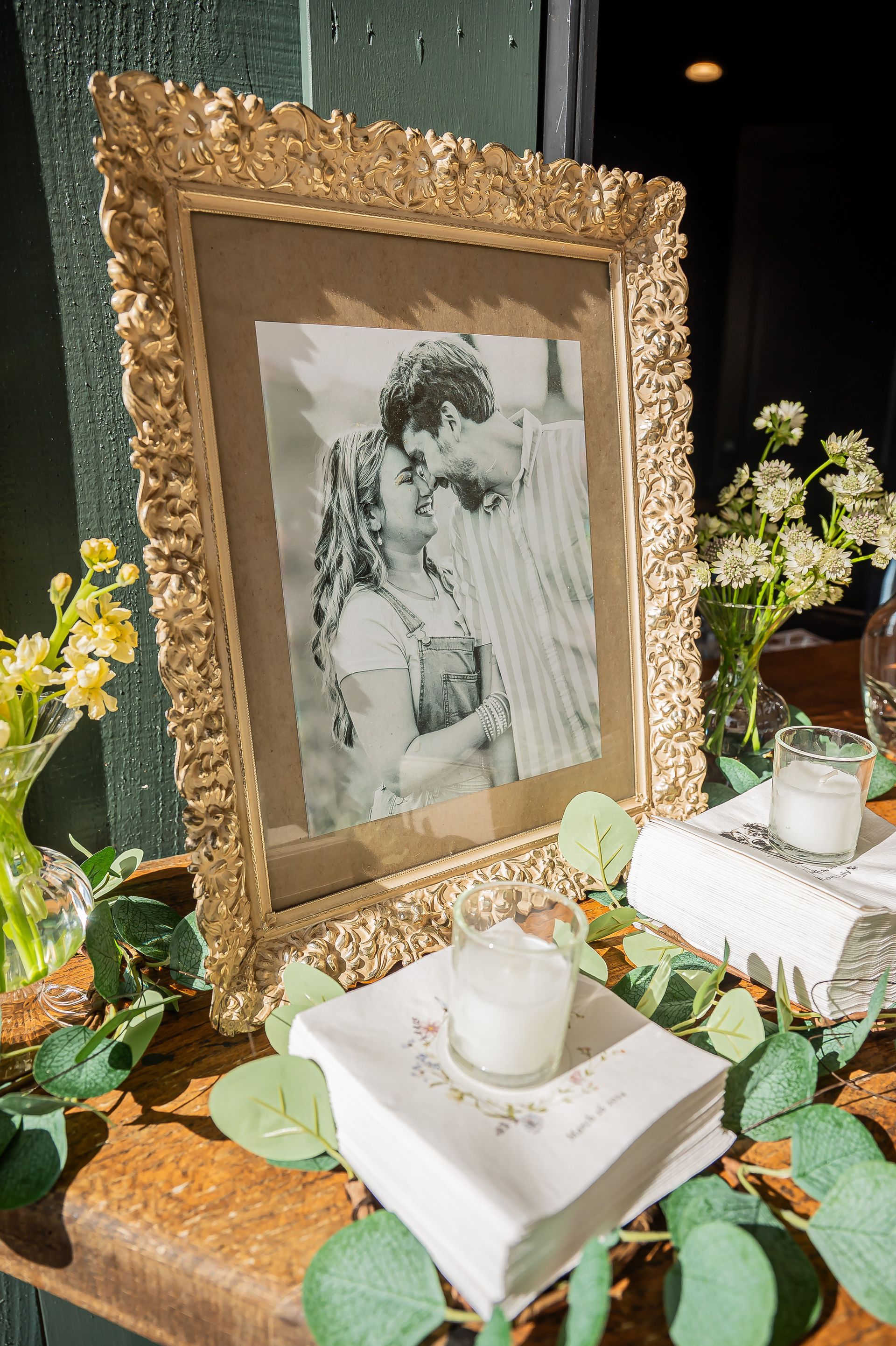 A framed picture of a man and woman kissing is sitting on a table.