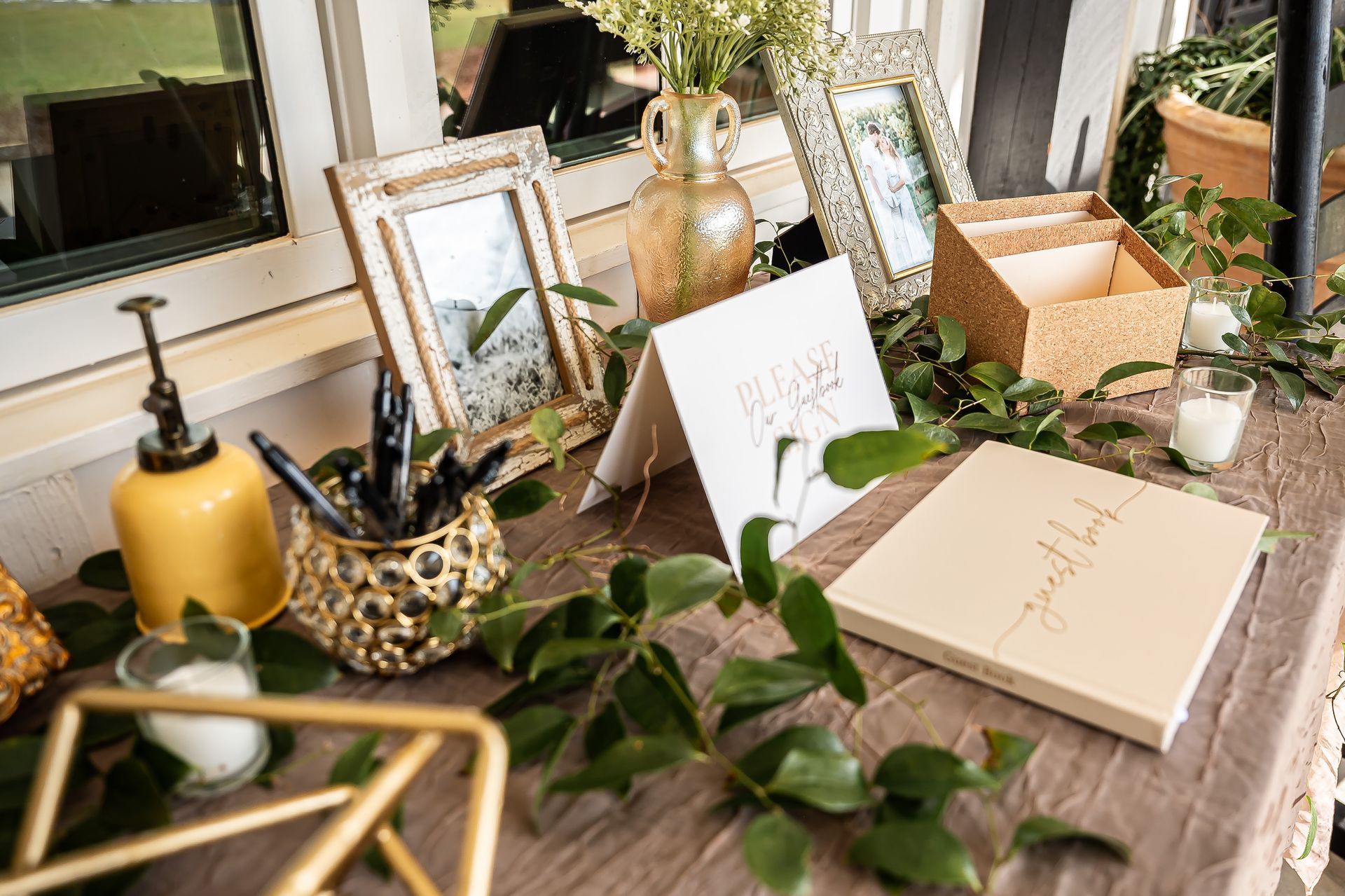 A table decorated with flowers , candles , cards , and pictures.