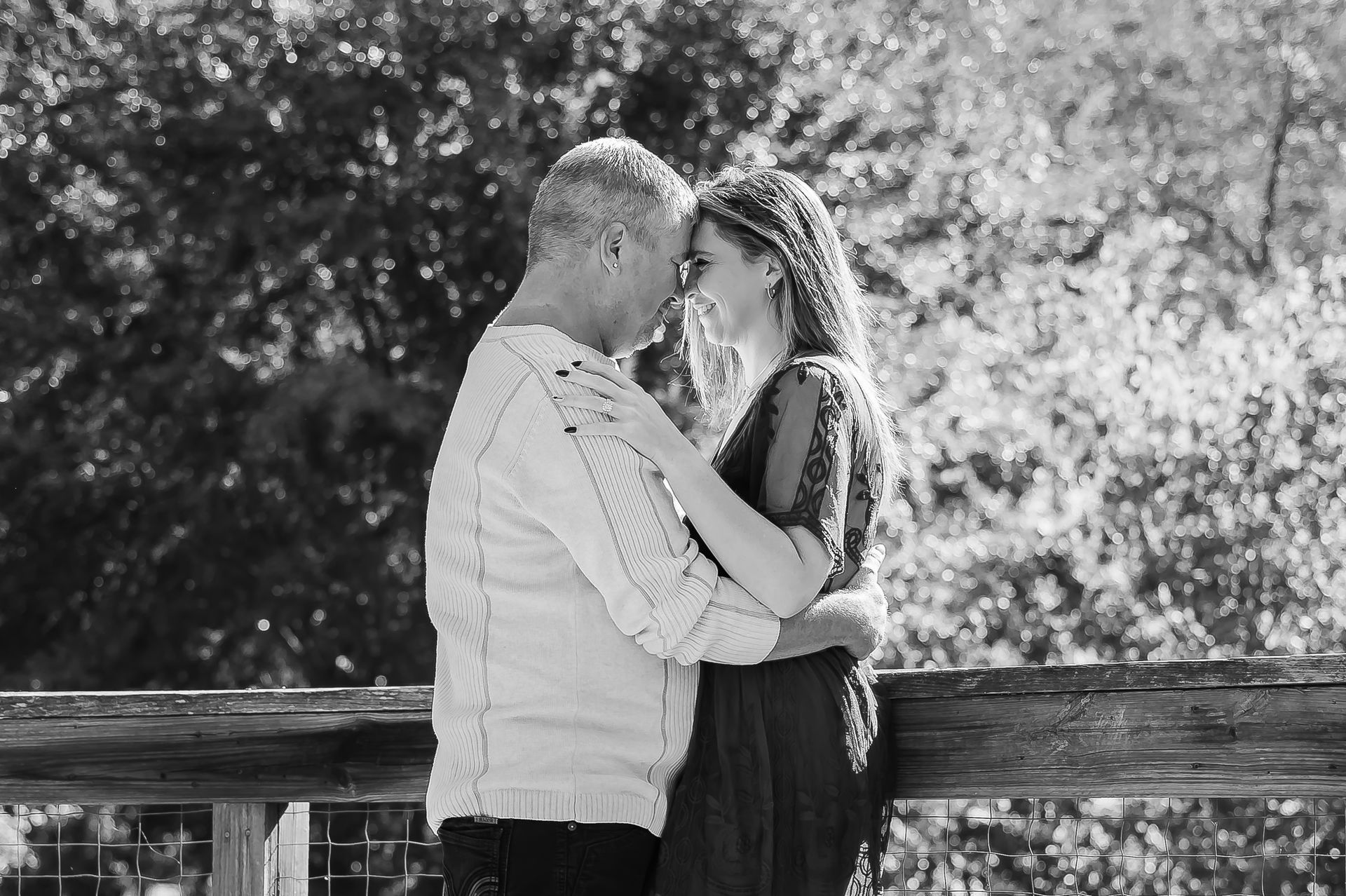 A black and white photo of a man and woman hugging each other.