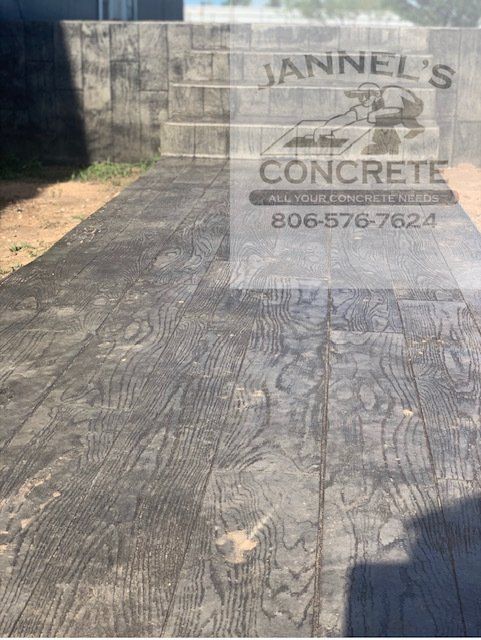A concrete driveway with a sign that says annel 's concrete
