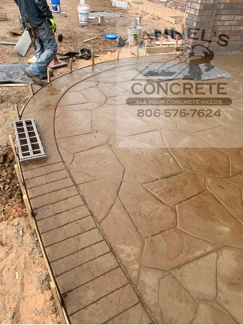 A concrete walkway is being built by a company called concrete