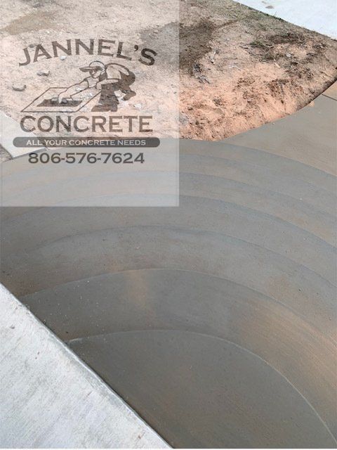 A sign for jannel 's concrete is on a concrete surface