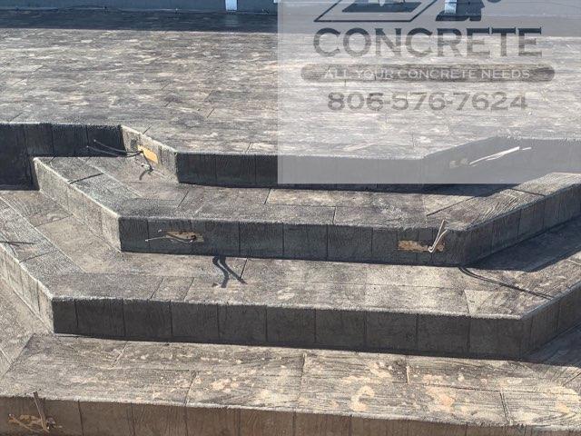 A set of concrete steps leading up to a house.