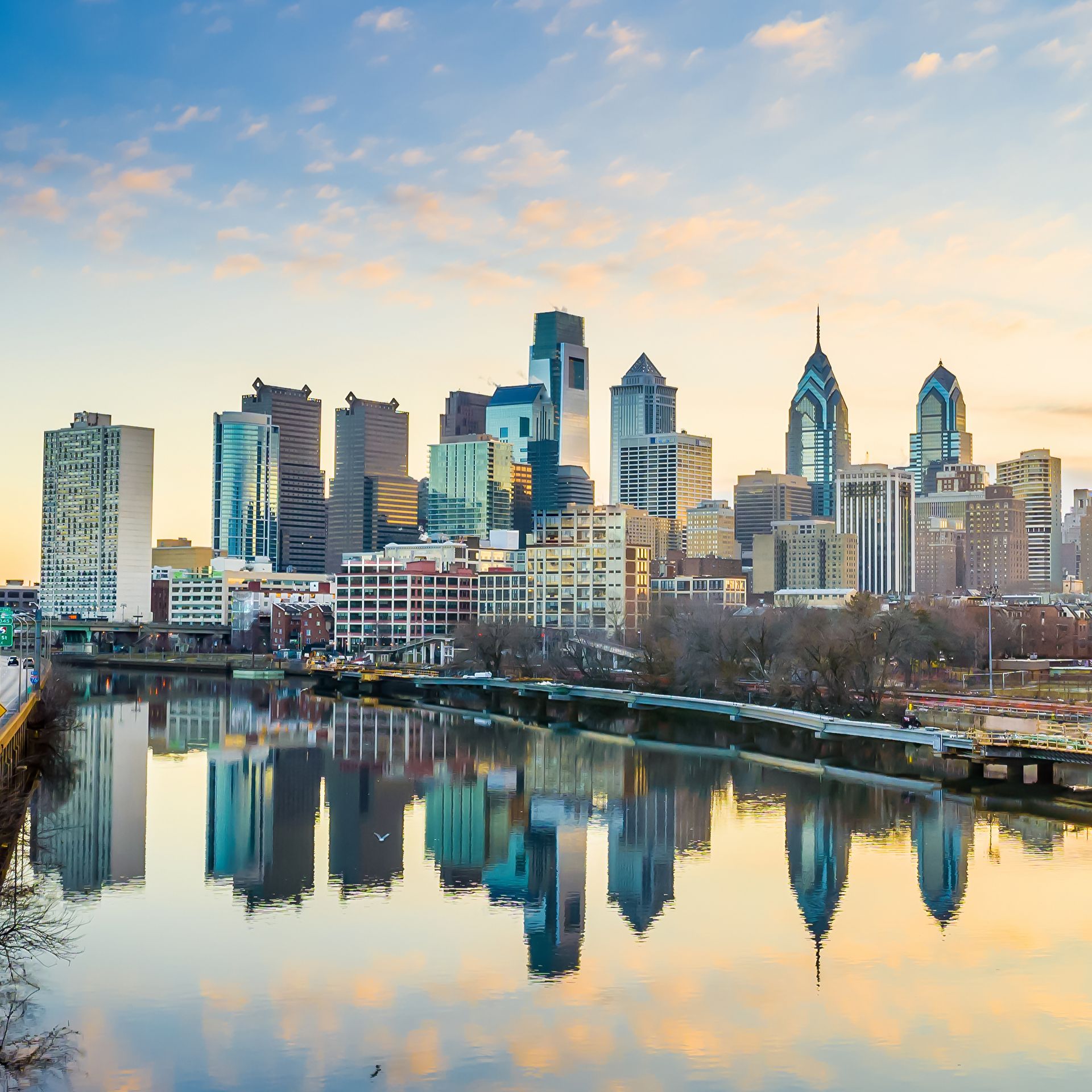 A man , woman and child are hugging each other and smiling.