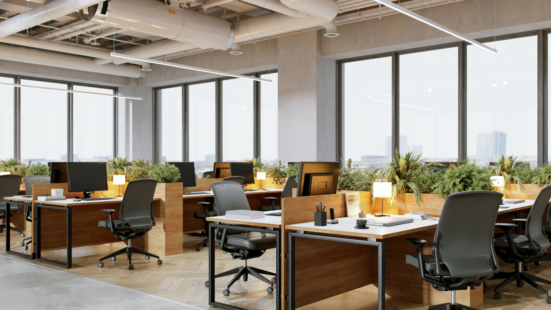 An empty office with lots of windows and desks and chairs.