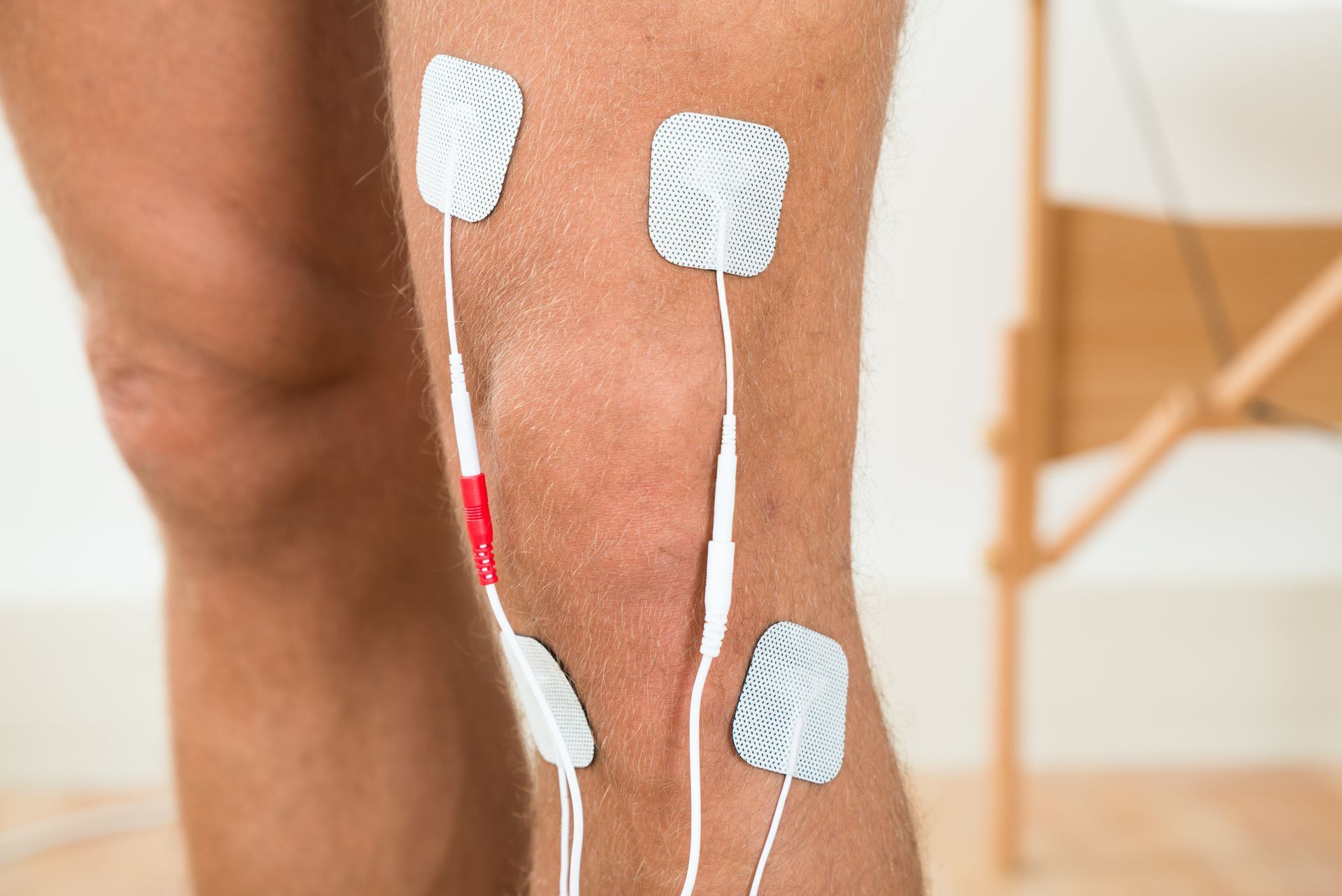 A close up of a person 's leg with electrodes on it.