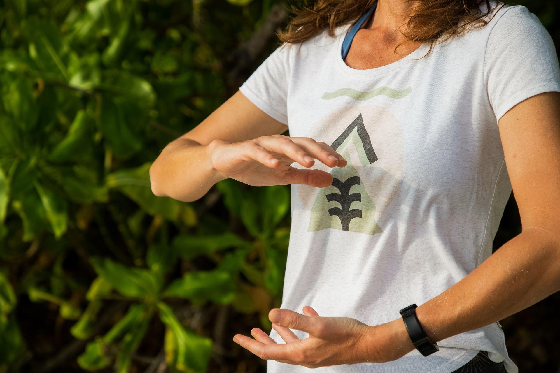 girl smiling in the snow while pulling her beanie