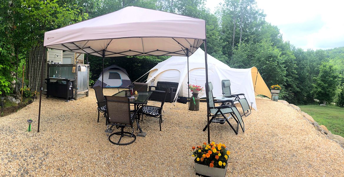 glamping site with ez-up and chairs