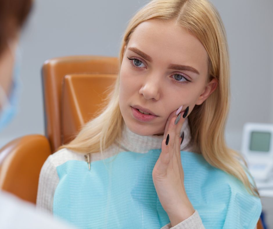 Woman with toothache at the dentist