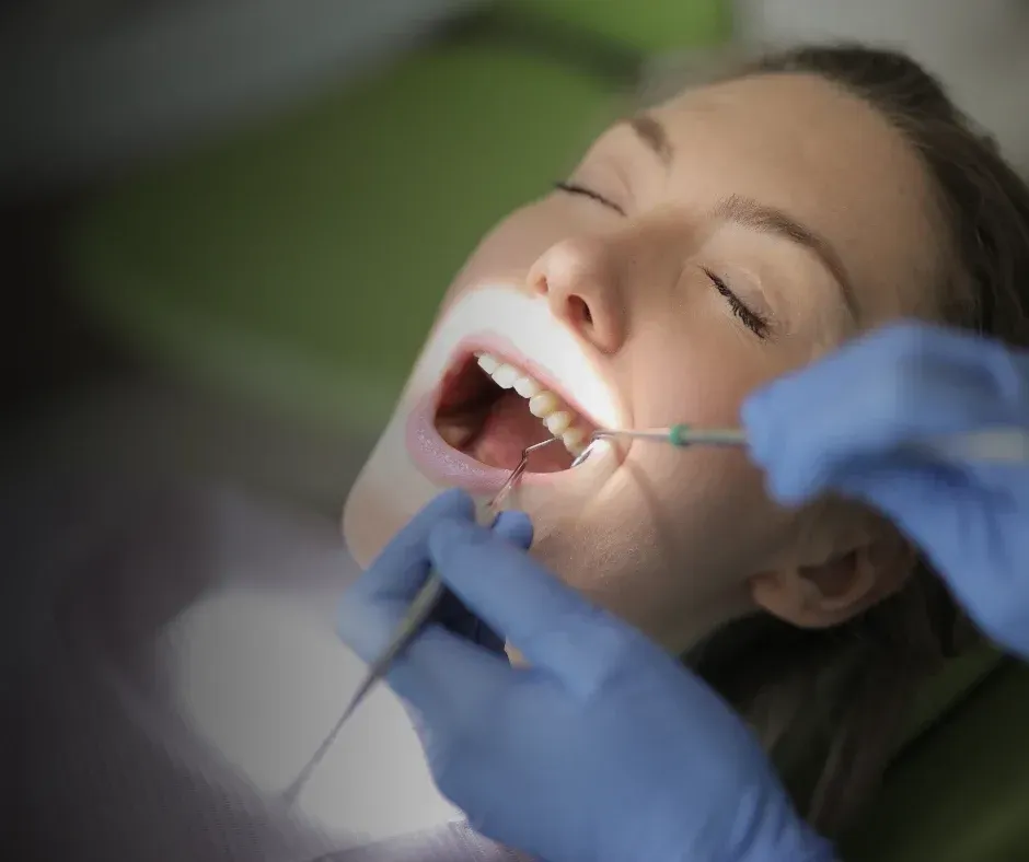 Dentist cleaning patient’s teeth