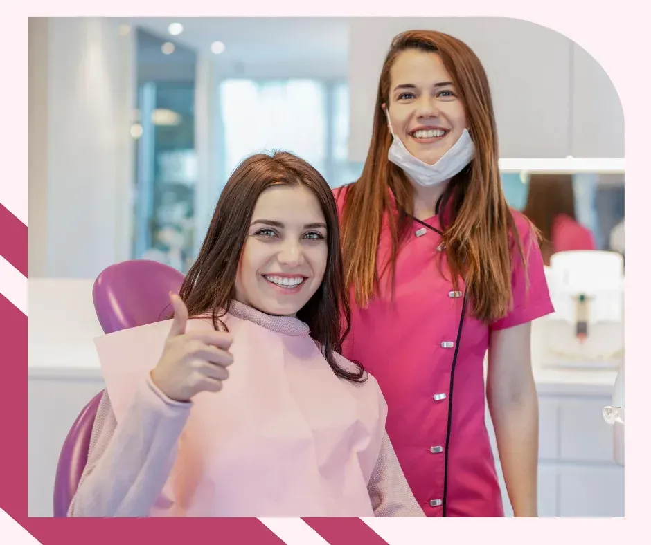 Smiling patient gives thumps- up beside dentist
