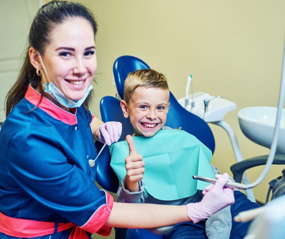 Child smiling at dentist during check-up.