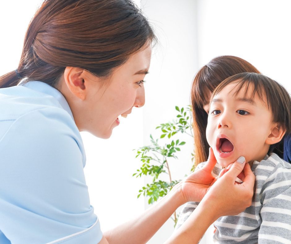 Dentist examining a young child’s mouth.
