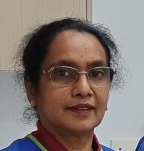 A close up of a woman wearing glasses and a blue shirt.