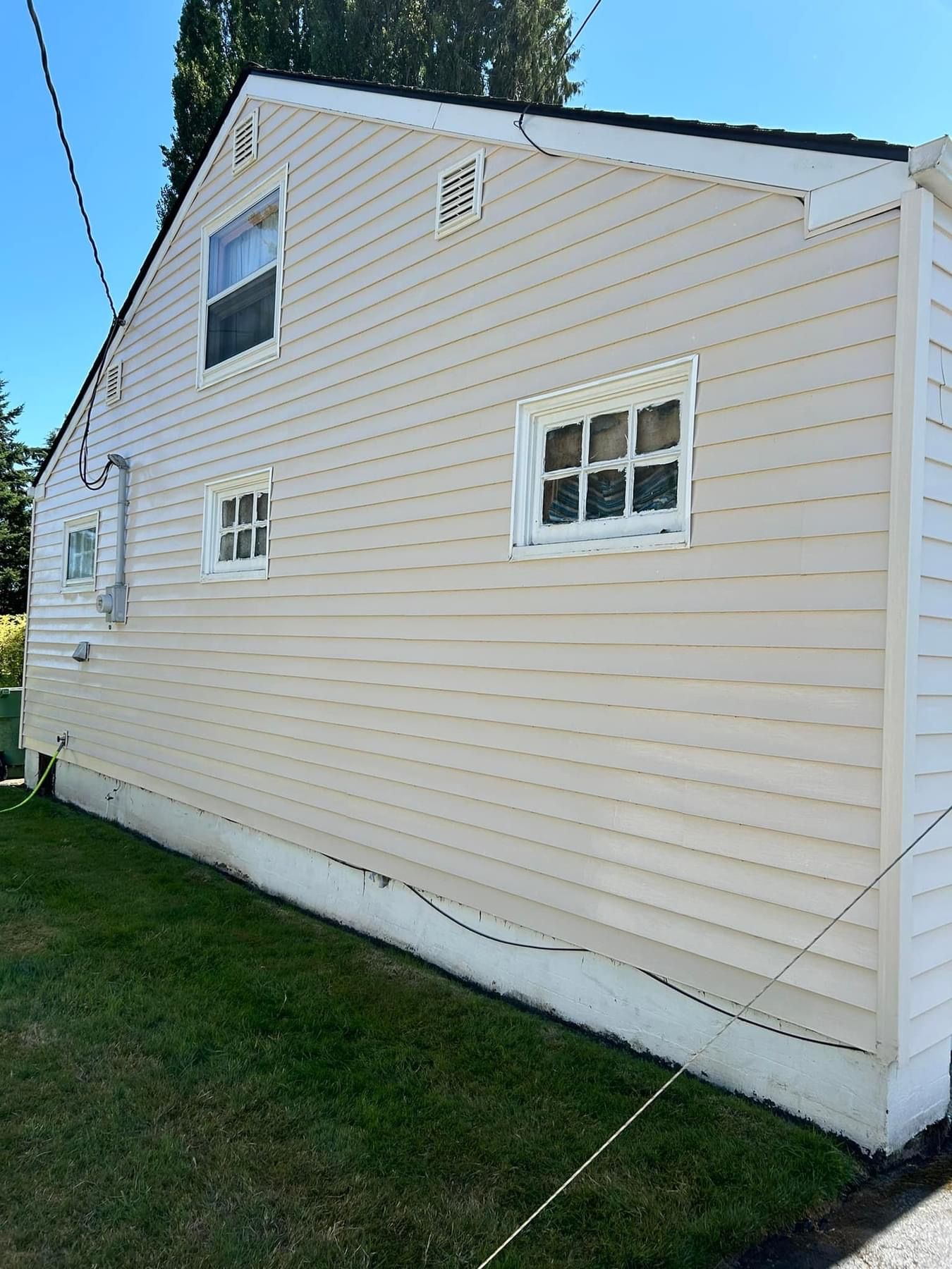 A white house with a window and shutters on it.