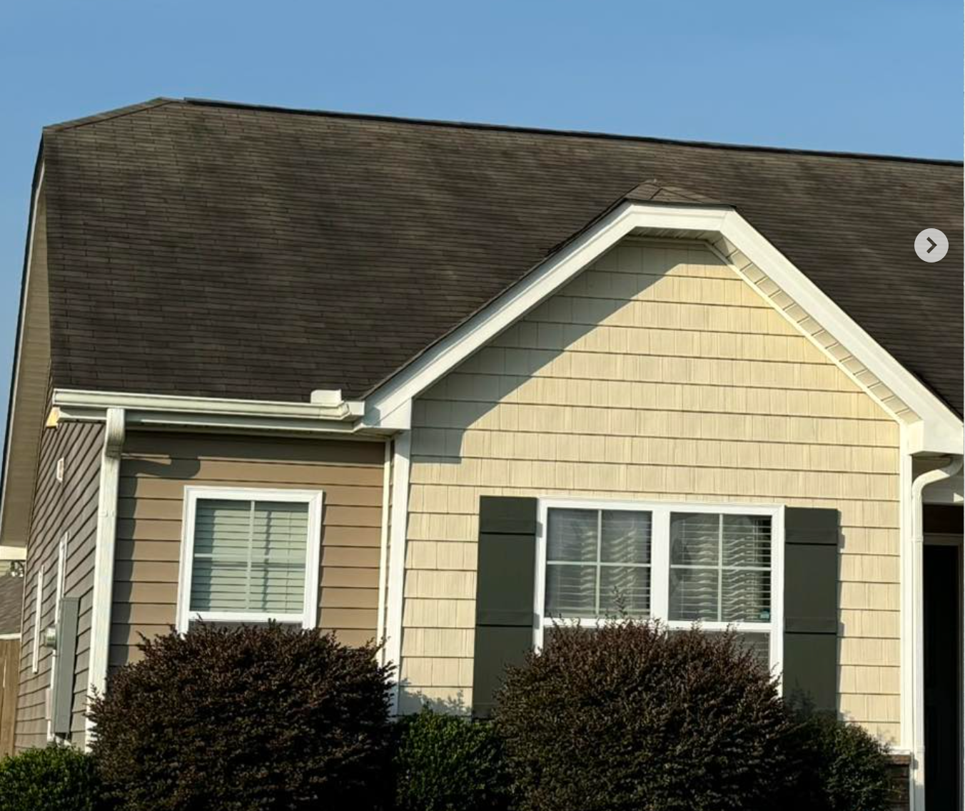 A house with a brown roof and white trim