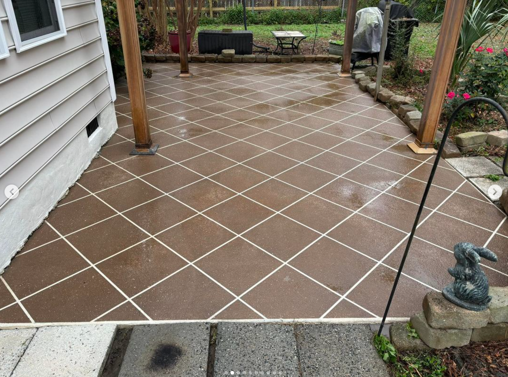 A patio with a stenciled pattern and a statue of a rabbit.