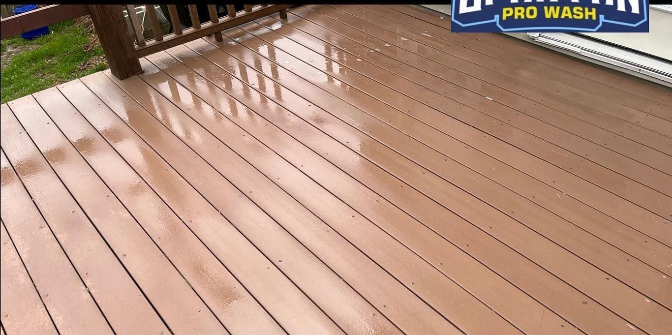 A wooden deck is being cleaned by a pro wash company.