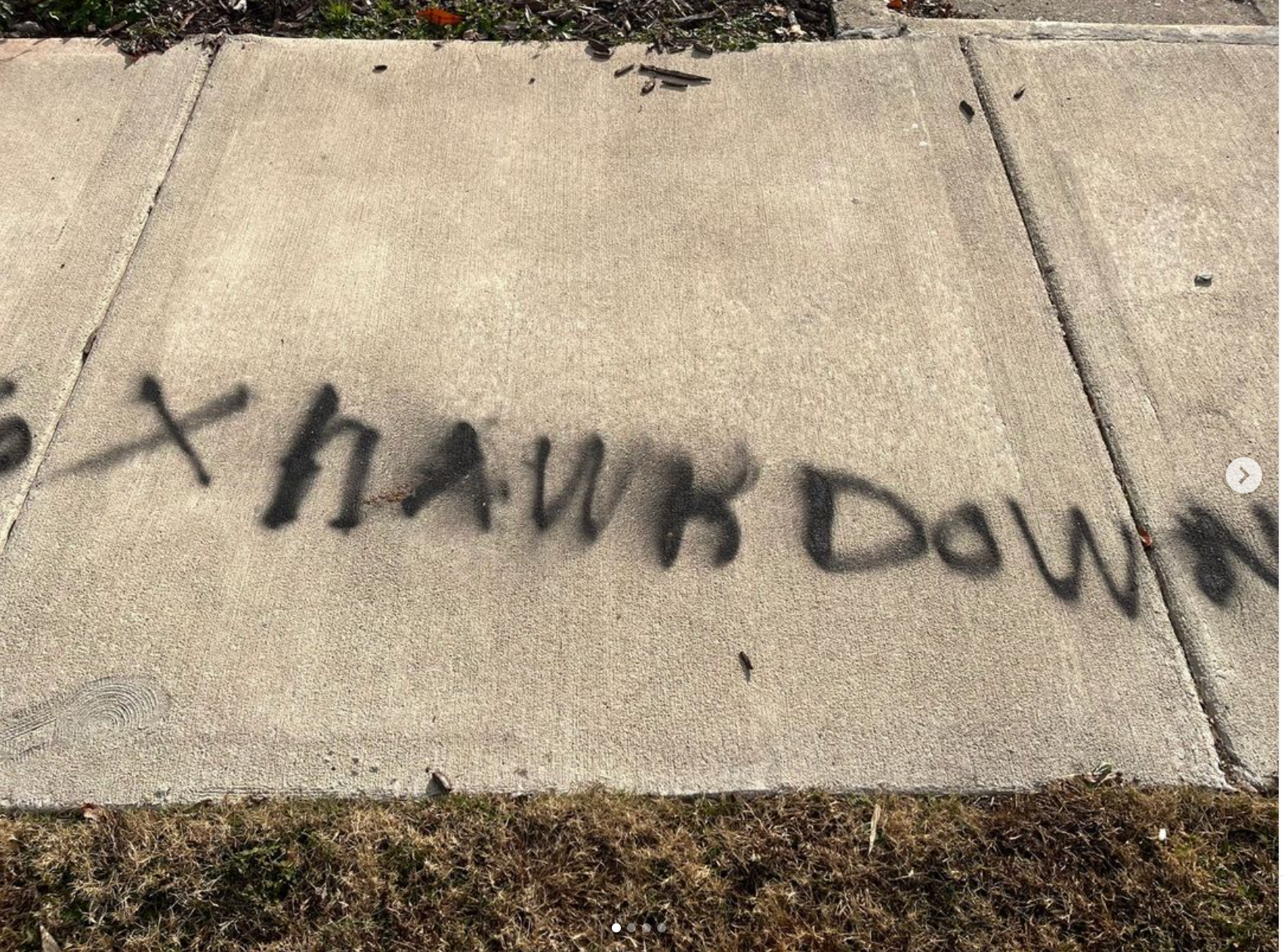 The word hawk down is spray painted on the sidewalk