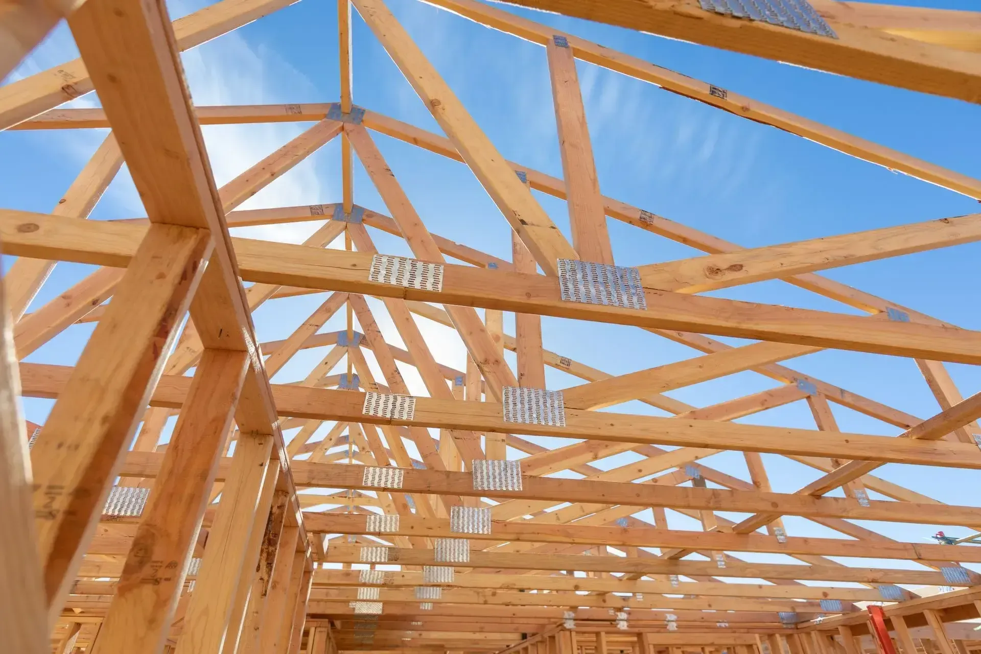 exposed frame of a house against a blue sky