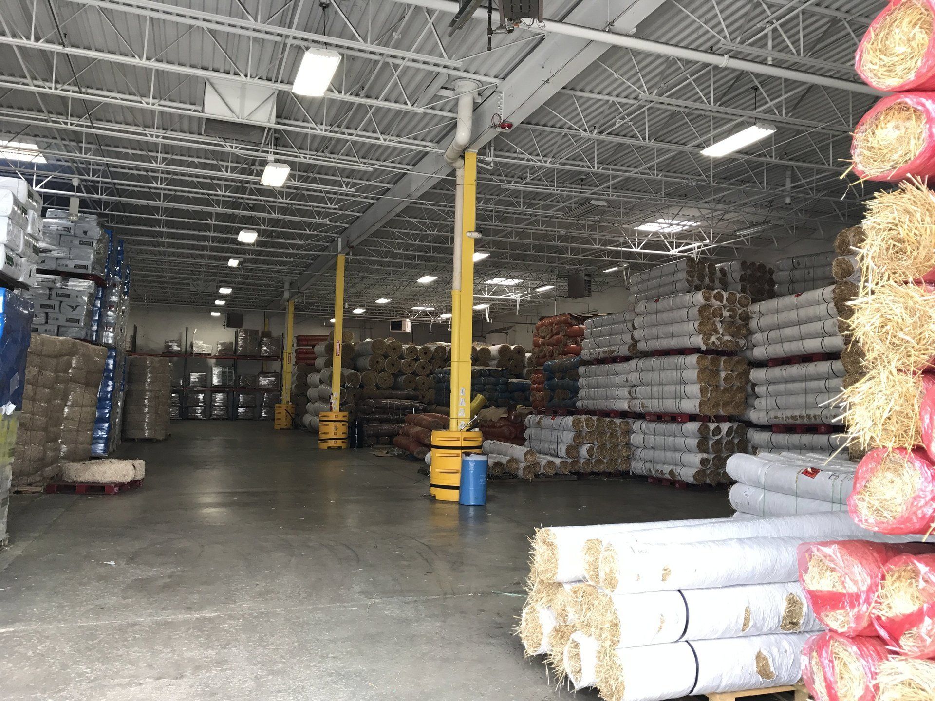 A large warehouse filled with lots of bags of hay.