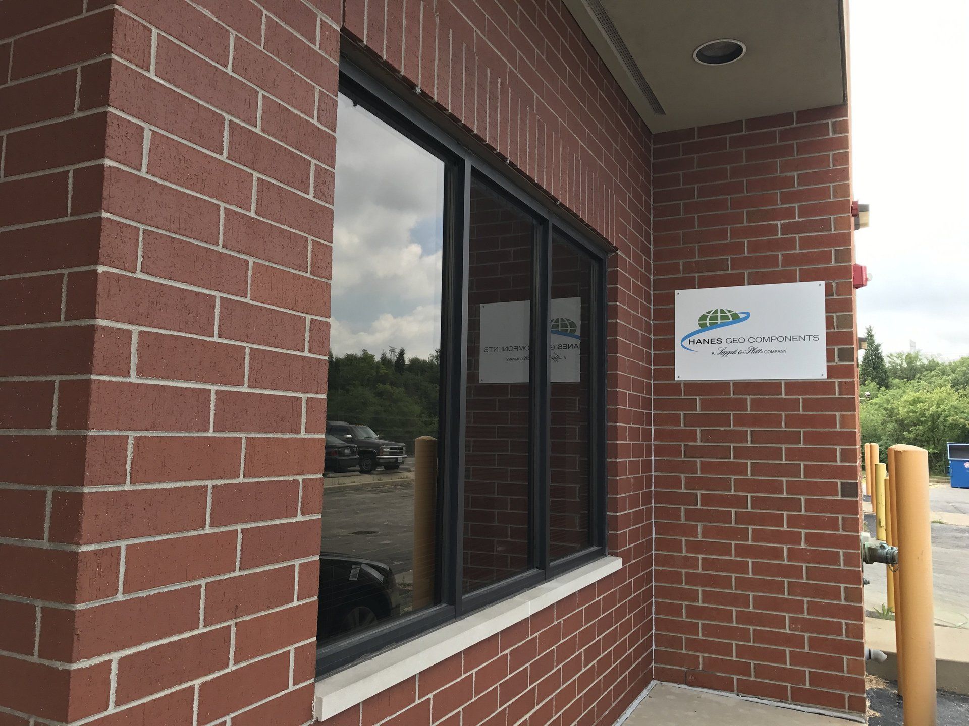 A brick building with a window and a sign that says ' a ' on it
