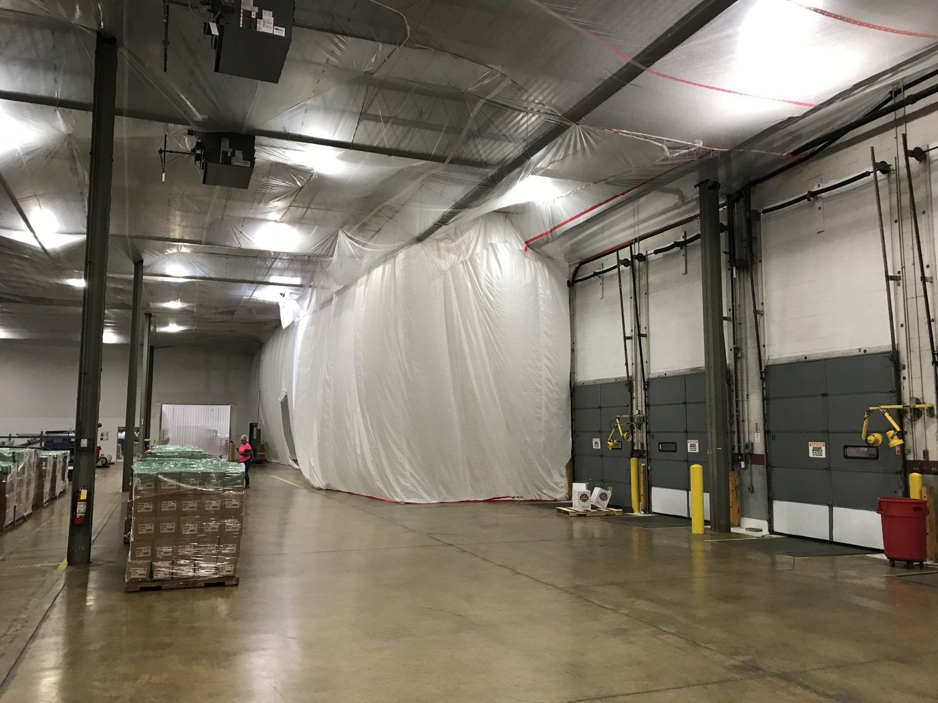 A large warehouse with a large white tarp covering the walls.