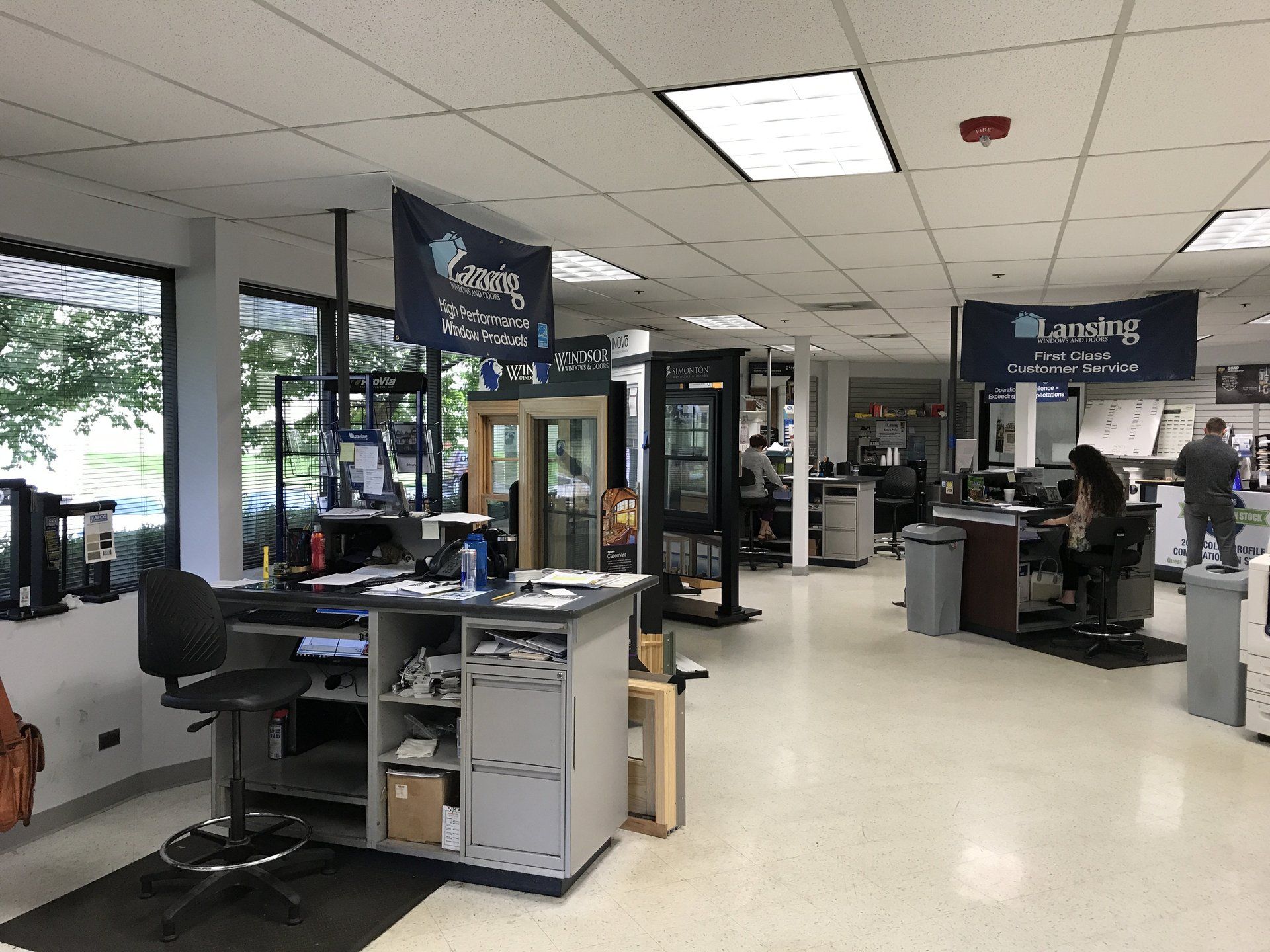 A large room with a lot of windows and signs on the ceiling.