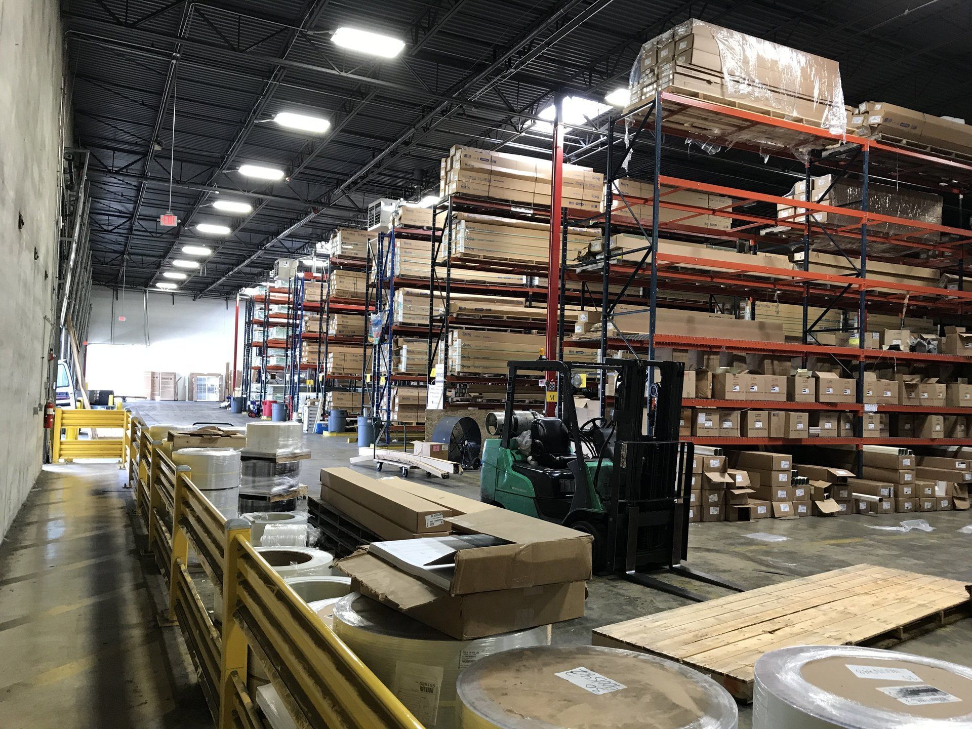 A large warehouse filled with lots of boxes and shelves.