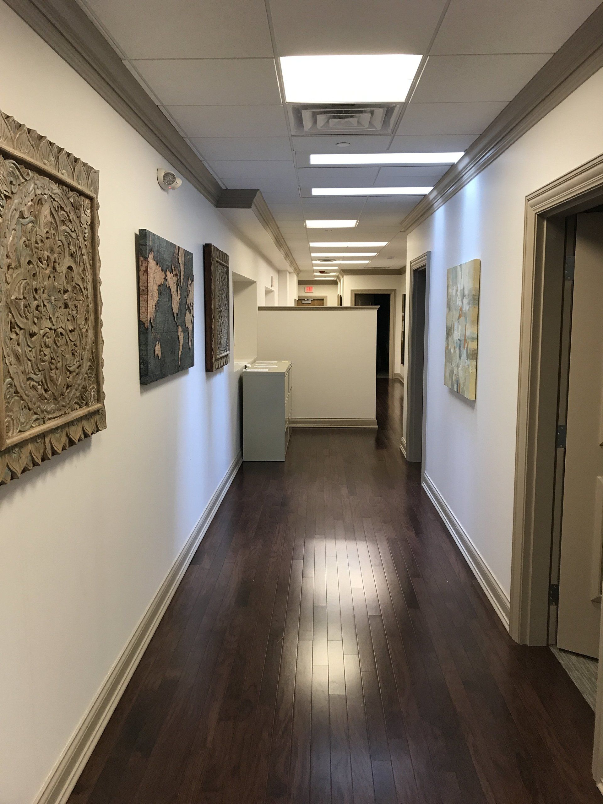 A long hallway with paintings on the wall